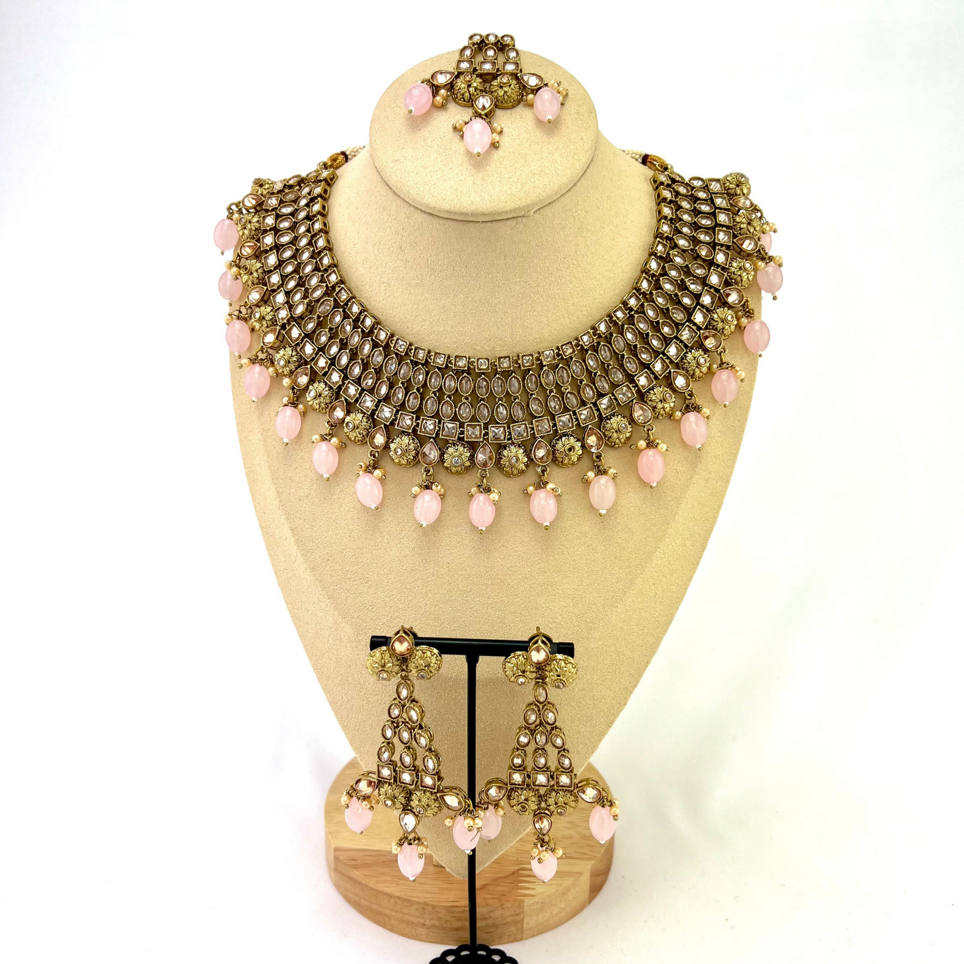 Necklace set with pink  beads and gold stone work.  Set includes necklace, tikka and earrings.  Prefect for Indian weddings, parties and special occasions.   Latest 2022 fashion. High end Indian fashion jewellery with top quality stones and beads.