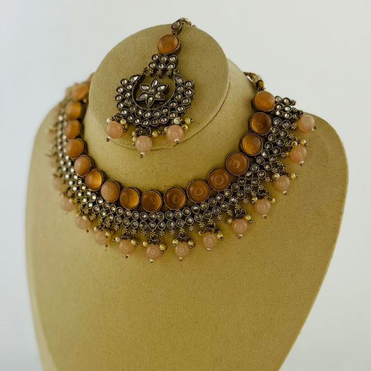 Necklace set with peach stones and beads. Set includes necklace, tikka & earrings.  Prefect for Indian weddings, parties and special occasions.   Latest 2023 fashion. High end Indian fashion jewellery with top quality stones and beads.