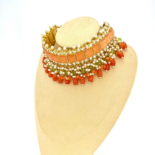 Choker set with with peach, clear stones and green, peach and orange beads,  Set includes choker, tikka and earrings.  Prefect for Indian weddings, parties and special occasions.  Latest 2022 fashion. High end Indian fashion jewellery with top quality stones and beads.