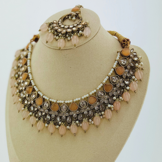 Necklace set with peach stones and beads.  Set includes necklace, tikka & earrings.  Prefect for Indian weddings, parties and special occasions.   Latest 2023 fashion. High end Indian fashion jewellery with top quality stones and beads.