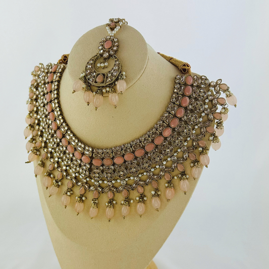 Necklace set with pink bead and stones.  Set includes necklace, tikka & earrings.  Prefect for Indian weddings, parties and special occasions.   Latest 2023 fashion. High end Indian fashion jewellery with top quality stones and beads.