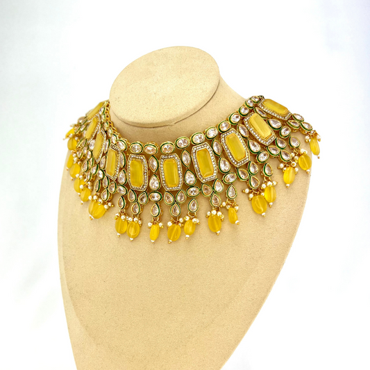 Necklace set with yellow beads and clear and yellow stones.  Set includes necklace, tikka and earrings.  Prefect for Indian weddings, parties and special occasions.  Latest 2022 fashion. High end Indian fashion jewellery with top quality stones and beads.