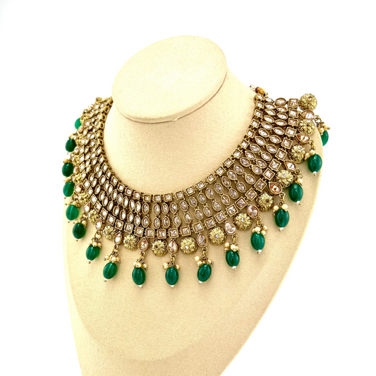 Necklace set with green beads and gold stone work.  Set includes necklace, tikka and earrings.  Prefect for Indian weddings, parties and special occasions.   Latest 2022 fashion. High end Indian fashion jewellery with top quality stones and beads.