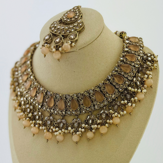 Necklace set with peach beads and stone.  Set includes necklace, tikka & earrings.  Prefect for Indian weddings, parties and special occasions.   Latest 2023 fashion. High end Indian fashion jewellery with top quality stones and beads.