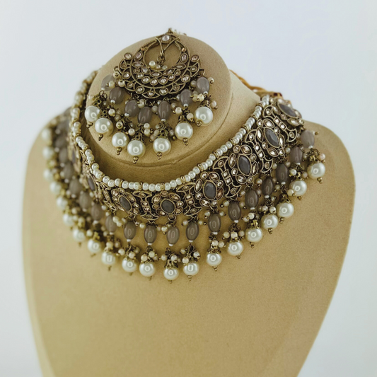 Necklace set with grey stones and white pearl beads.  Set includes necklace, tikka & earrings.  Prefect for Indian weddings, parties and special occasions.   Latest 2023 fashion. High end Indian fashion jewellery with top quality stones and beads.