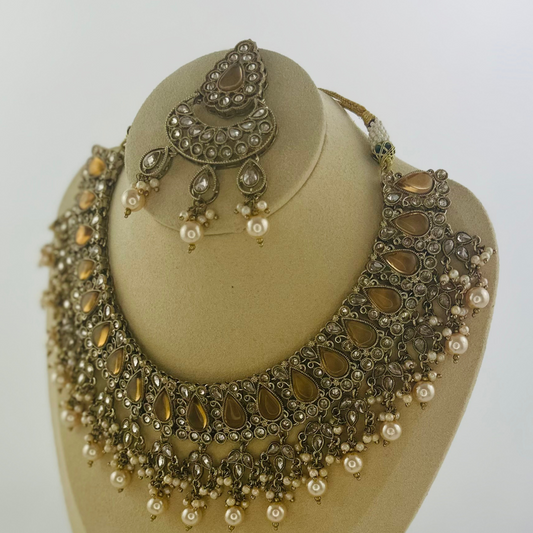 Necklace set with bronze stones and white pearl beads.  Set includes necklace, tikka & earrings.  Prefect for Indian weddings, parties and special occasions.   Latest 2023 fashion. High end Indian fashion jewellery with top quality stones and beads.