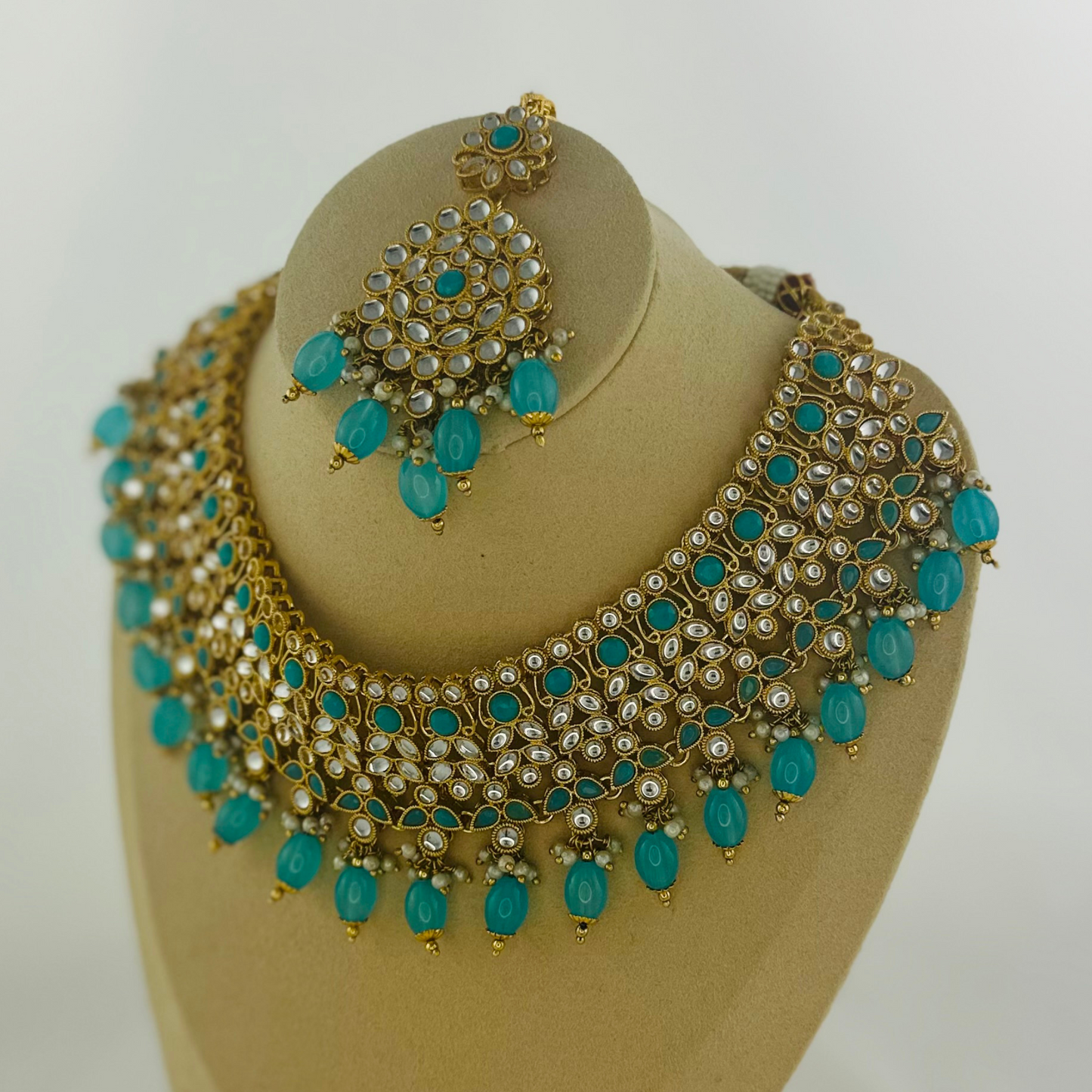 Necklace set with turquoise stones and beads.  Set includes necklace, tikka & earrings.  Prefect for Indian weddings, parties and special occasions.   Latest 2023 fashion. High end Indian fashion jewellery with top quality stones and beads.