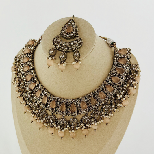 Necklace set with peach stones and beads.  Set includes necklace, tikka & earrings.  Prefect for Indian weddings, parties and special occasions.   Latest 2023 fashion. High end Indian fashion jewellery with top quality stones and beads.