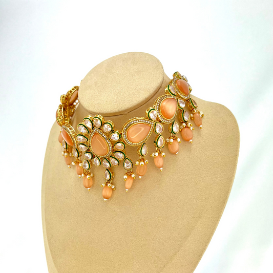 ﻿Choker set with peach, clear stones and peach beads.  Set includes choker, tikka and earrings.  Prefect for Indian weddings, parties and special occasions.  Latest 2022 fashion. High end Indian fashion jewellery with top quality stones and beads.