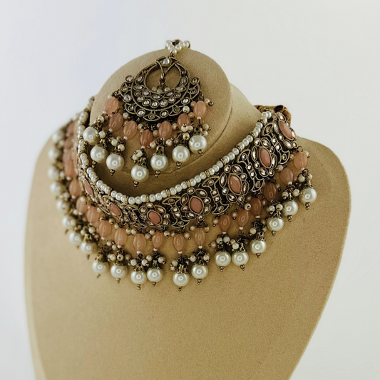 Necklace set with peach stones and white pearl beads.  Set includes necklace, tikka & earrings.  Prefect for Indian weddings, parties and special occasions.   Latest 2023 fashion. High end Indian fashion jewellery with top quality stones and beads.