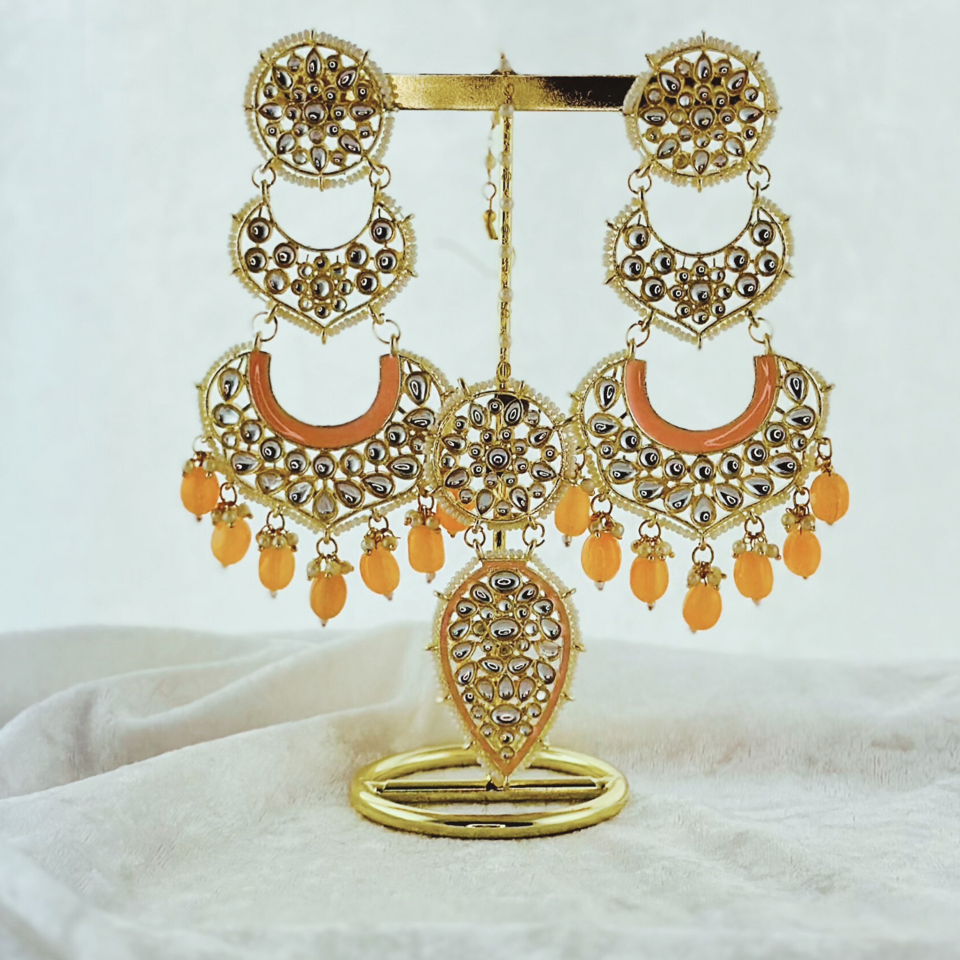 Tikka & Earring Set in peach.  High quality beads, pearls and stone work.   Latest 2023 fashion for weddings, parties and special occasions 