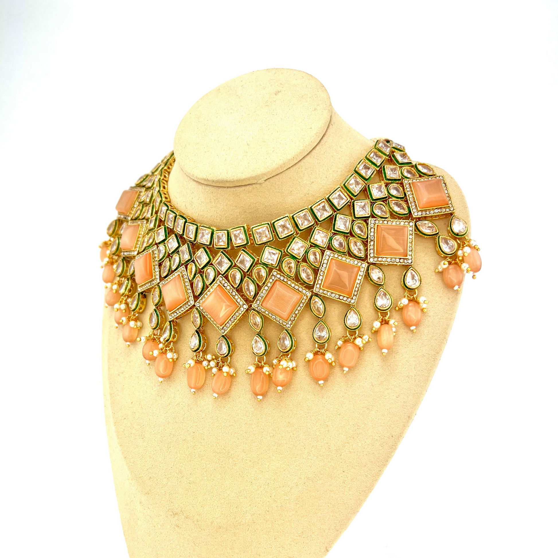 Necklace set with peach beads and peach and clear stone.  Set includes necklace, tikka & earrings.  Prefect for Indian weddings, parties and special occasions.   Latest 2022 fashion. High end Indian fashion jewellery with top quality stones and beads.