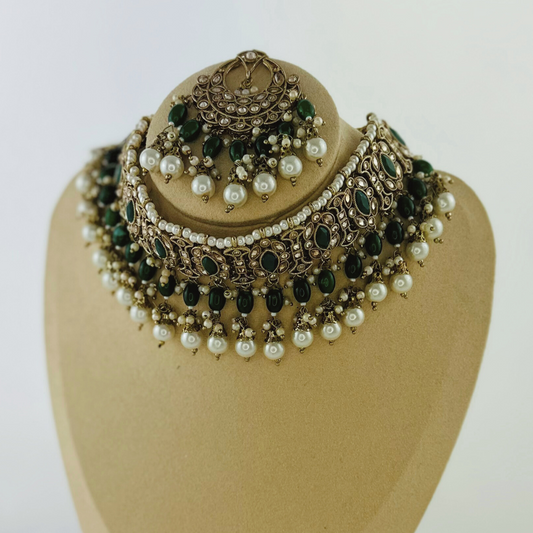 Necklace set with green stones and white pearl beads.  Set includes necklace, tikka & earrings.  Prefect for Indian weddings, parties and special occasions.   Latest 2023 fashion. High end Indian fashion jewellery with top quality stones and beads.