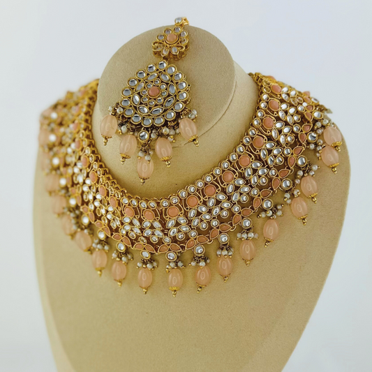 Necklace set with peach stones and beads.  Set includes necklace, tikka & earrings.  Prefect for Indian weddings, parties and special occasions.   Latest 2023 fashion. High end Indian fashion jewellery with top quality stones and beads.