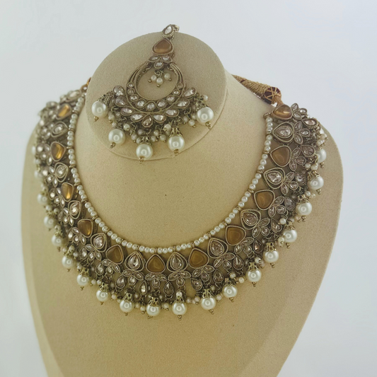 Necklace set with bronze stones and white pearl beads.  Set includes necklace, tikka & earrings.  Prefect for Indian weddings, parties and special occasions.   Latest 2023 fashion. High end Indian fashion jewellery with top quality stones and beads.