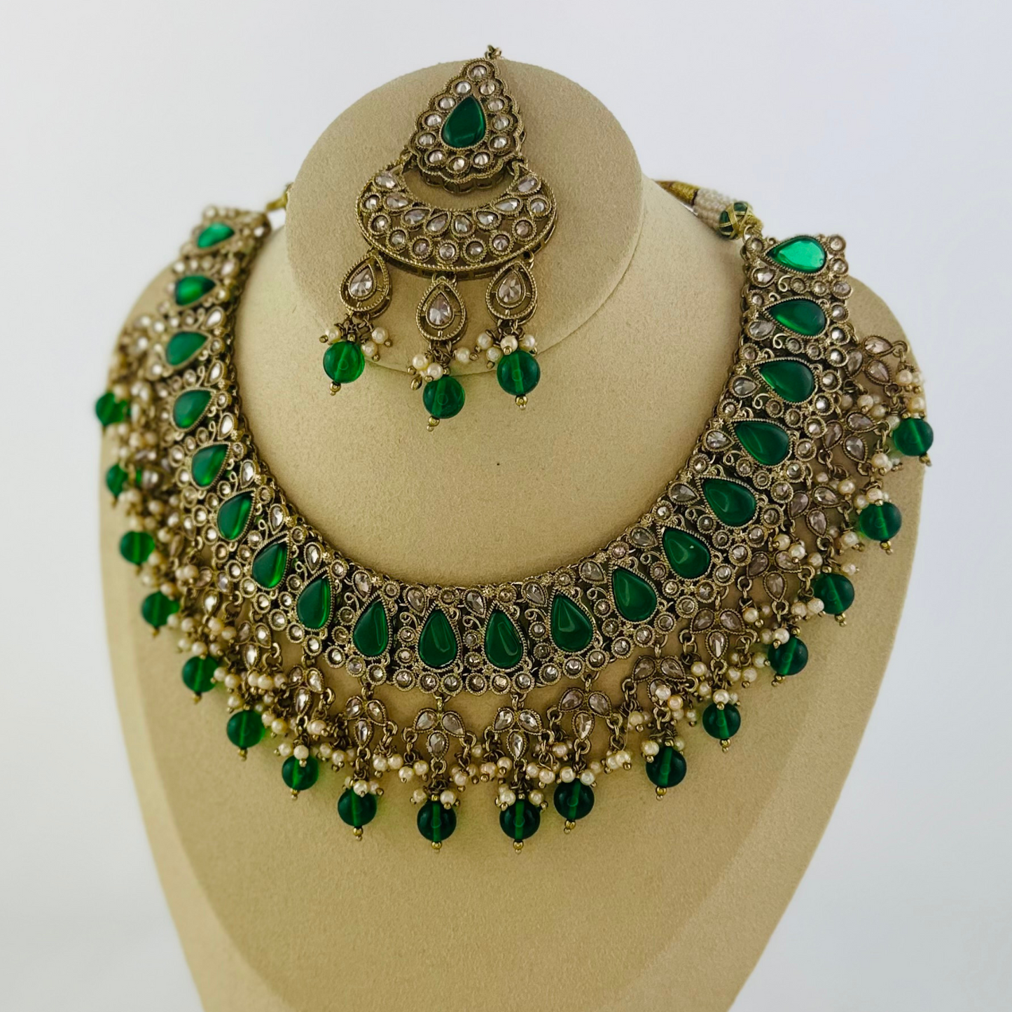 Necklace set with green beads and stone.  Set includes necklace, tikka & earrings.  Prefect for Indian weddings, parties and special occasions.   Latest 2023 fashion. High end Indian fashion jewellery with top quality stones and beads.