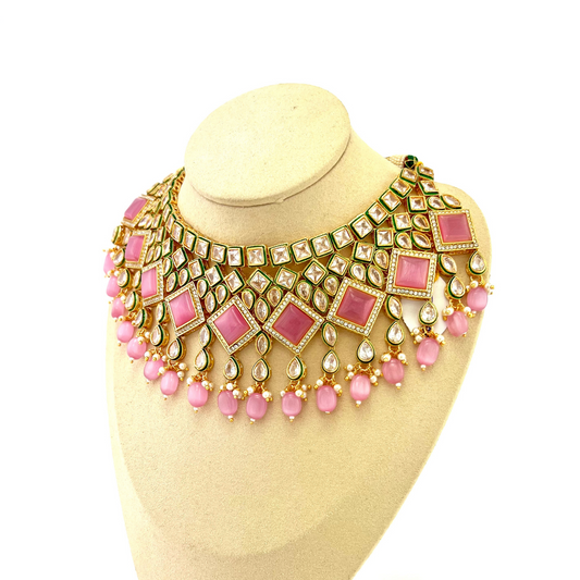 Necklace set with pink beads and pink and clear stone.  Set includes necklace, tikka & earrings.  Prefect for Indian weddings, parties and special occasions.   Latest 2022 fashion. High end Indian fashion jewellery with top quality stones and beads.