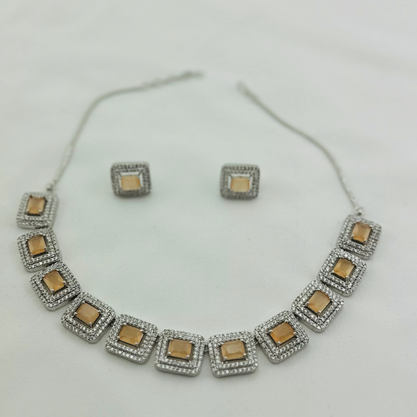 Necklace set with peach and clear stones.  Set includes necklace & earrings.  Prefect for Indian weddings, parties and special occasions.   Latest 2023 fashion. High end Indian fashion jewellery with top quality stones and beads.