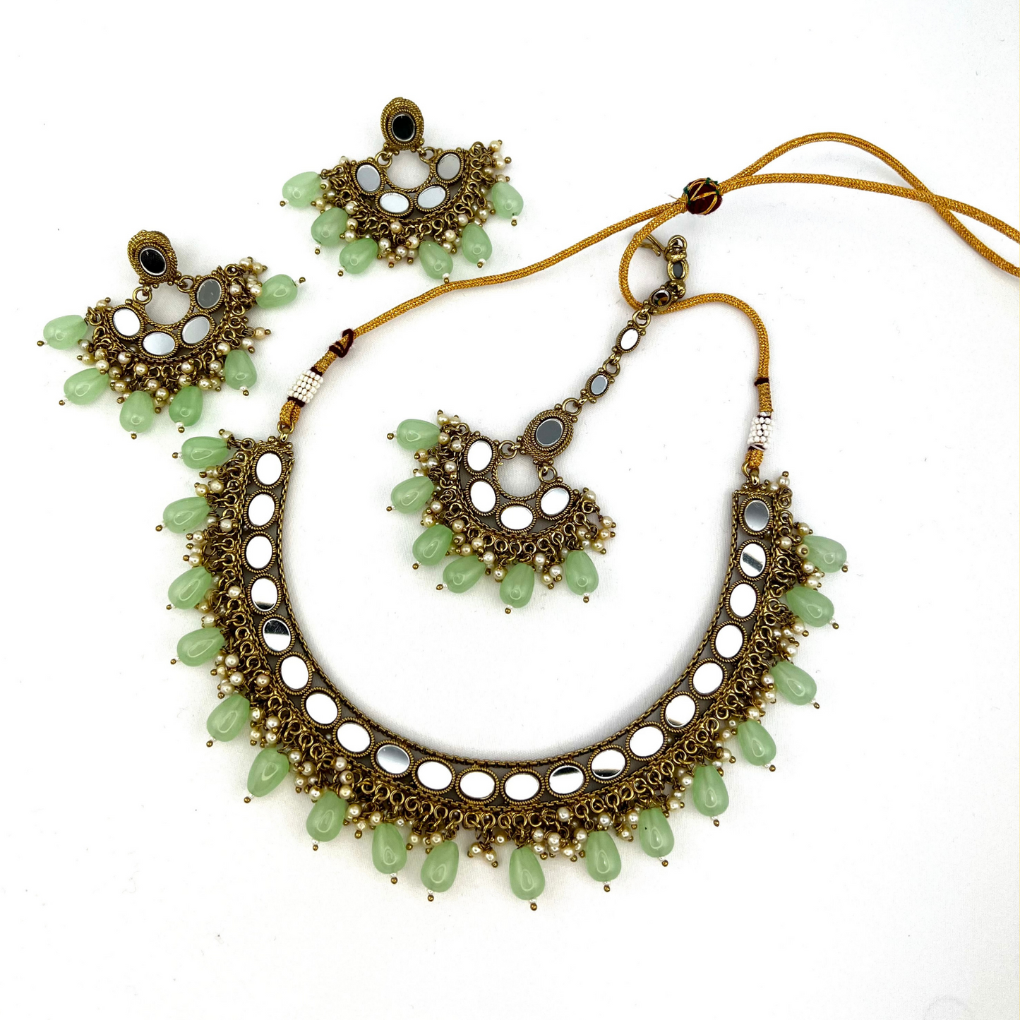 Mirror necklace set with green beads and small white pearls.  Set includes necklace, tikka and earrings.  Prefect for Indian parties, weddings and special occasions.   Latest 2022 fashion.