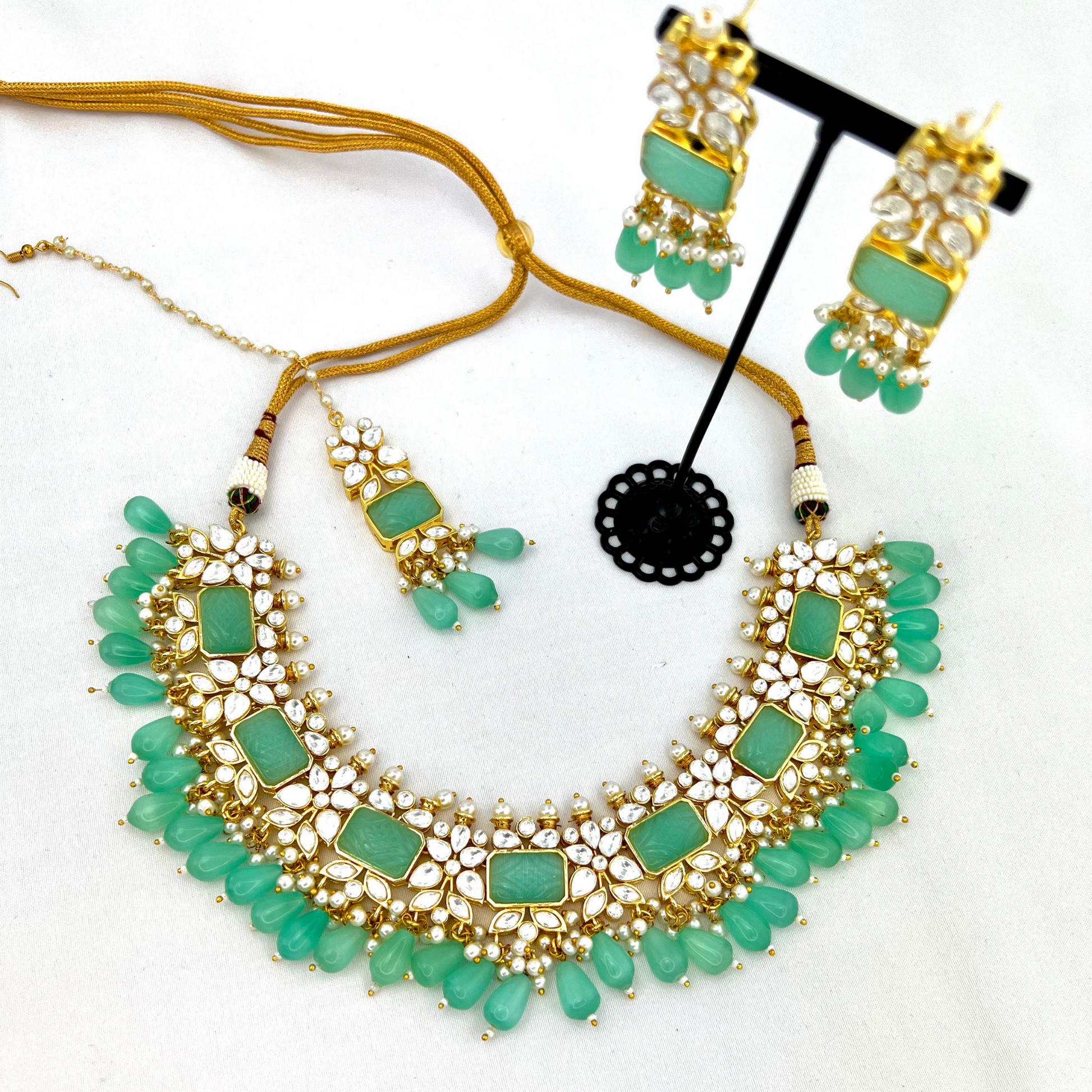 Necklace set with turquoise beads, clear and turquoise stones.  Set includes necklace, tikka & earrings.  Prefect for Indian weddings, parties and special occasions.   Latest 2022 fashion. High end Indian fashion jewellery with top quality stones and beads.