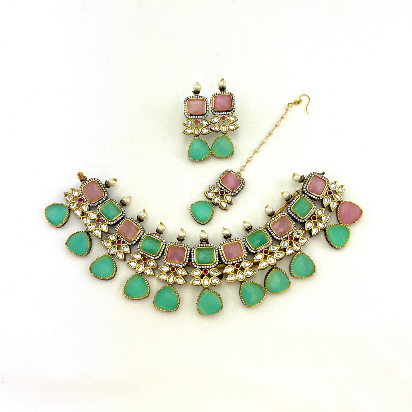 Necklace set with green, pink and silver stone work finished with small white pearls.  Set includes necklace, tikka and earrings.  Prefect for Indian parties, weddings and special occasions.   Latest 2022 fashion 