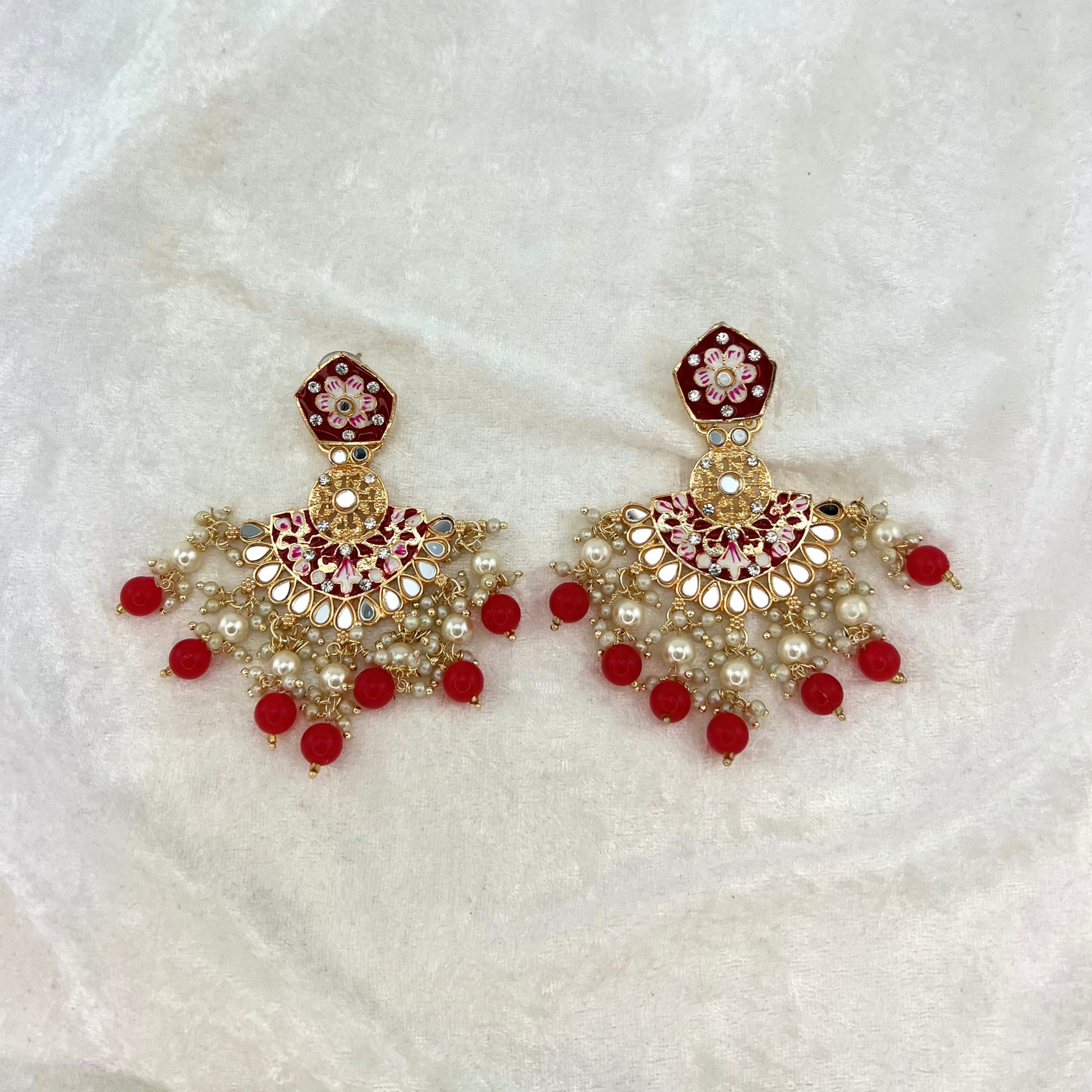 High quality hand painted earrings in Red with pearls, beads, mirrors and stone work. Latest 2022 indian jewellery for weddings, parties and special occasions.